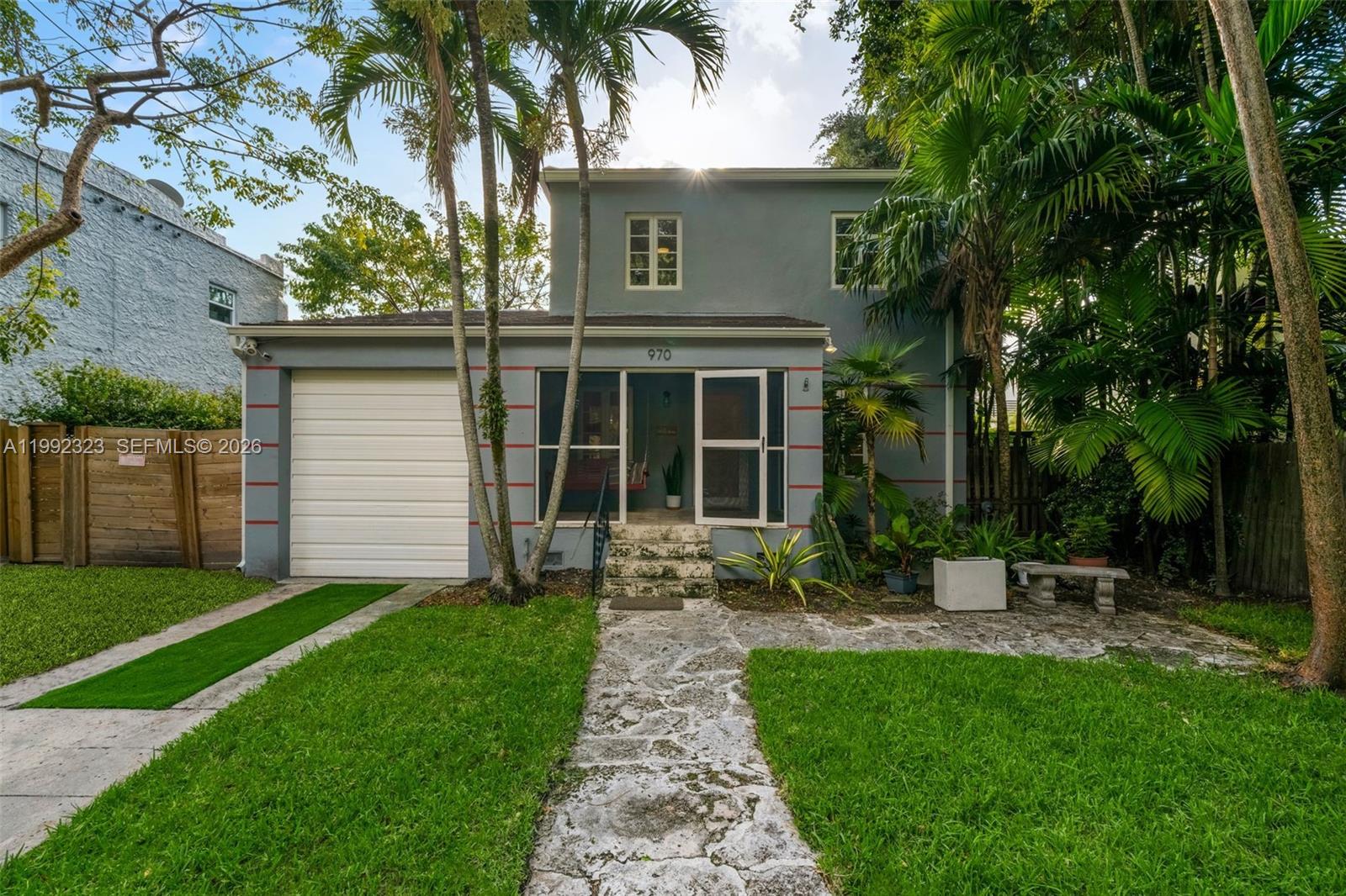 970 Northwest 10th Avenue Miami, FL 33136 - Photo 2 of 34 a front view of a house with garden and porch