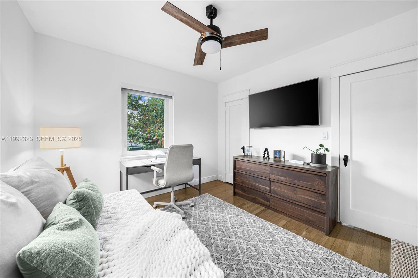 970 Northwest 10th Avenue Miami, FL 33136 - Photo 21 of 34 a bedroom with a bed and a flat screen tv