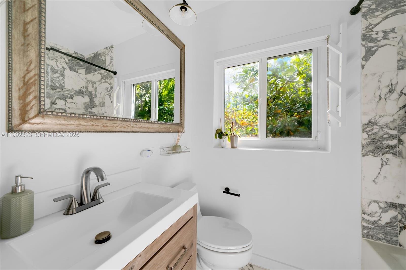 970 Northwest 10th Avenue Miami, FL 33136 - Photo 24 of 34 a bathroom with a toilet sink and window