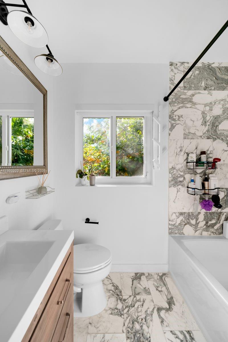 970 Northwest 10th Avenue Miami, FL 33136 - Photo 25 of 34 a bathroom with a sink toilet and window