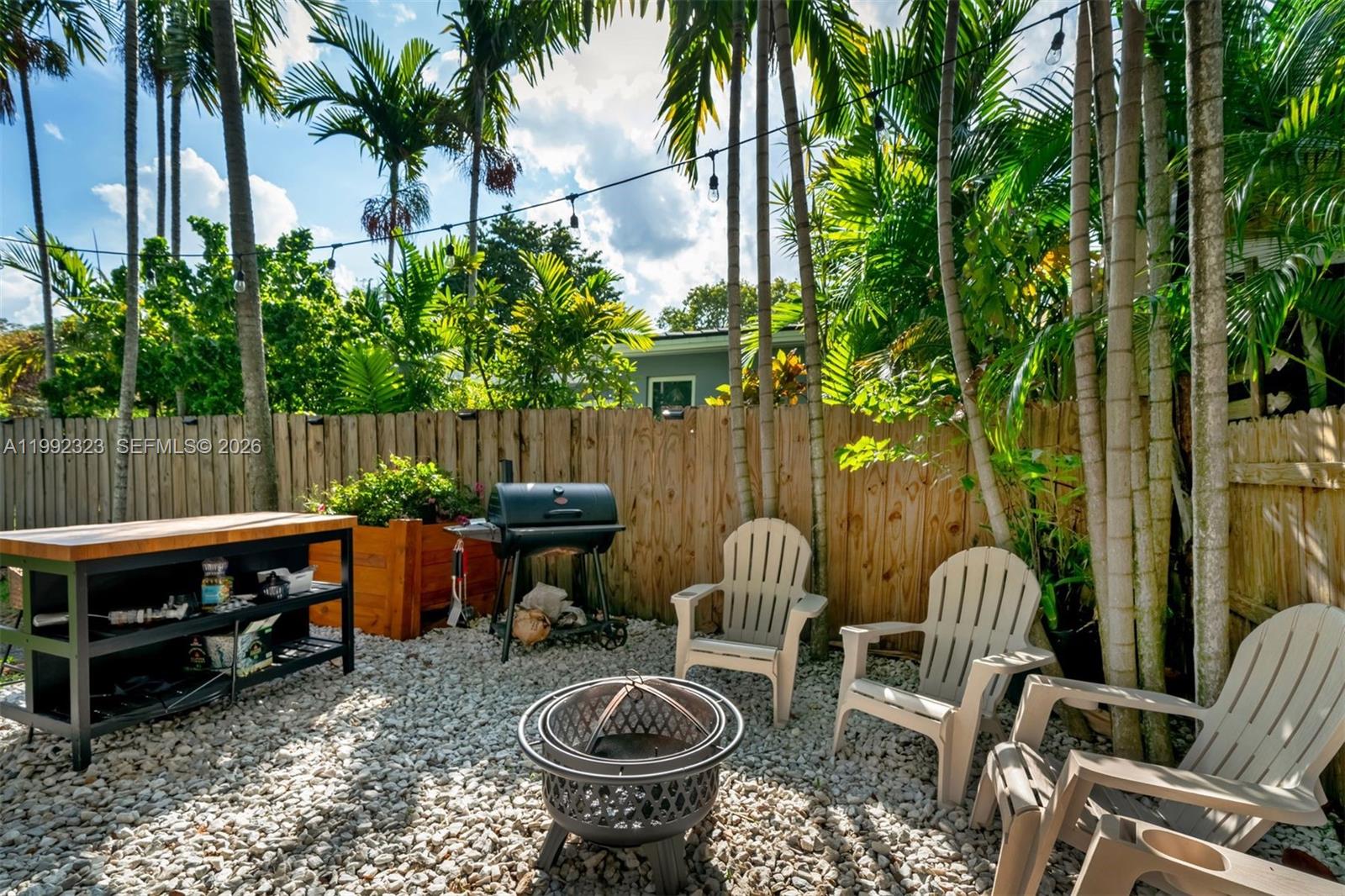 970 Northwest 10th Avenue Miami, FL 33136 - Photo 30 of 34 a backyard of a house with barbeque oven table and chairs