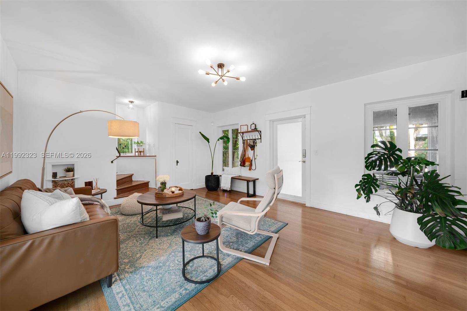 970 Northwest 10th Avenue Miami, FL 33136 - Photo 7 of 34 a living room with furniture a potted plant and a chandelier