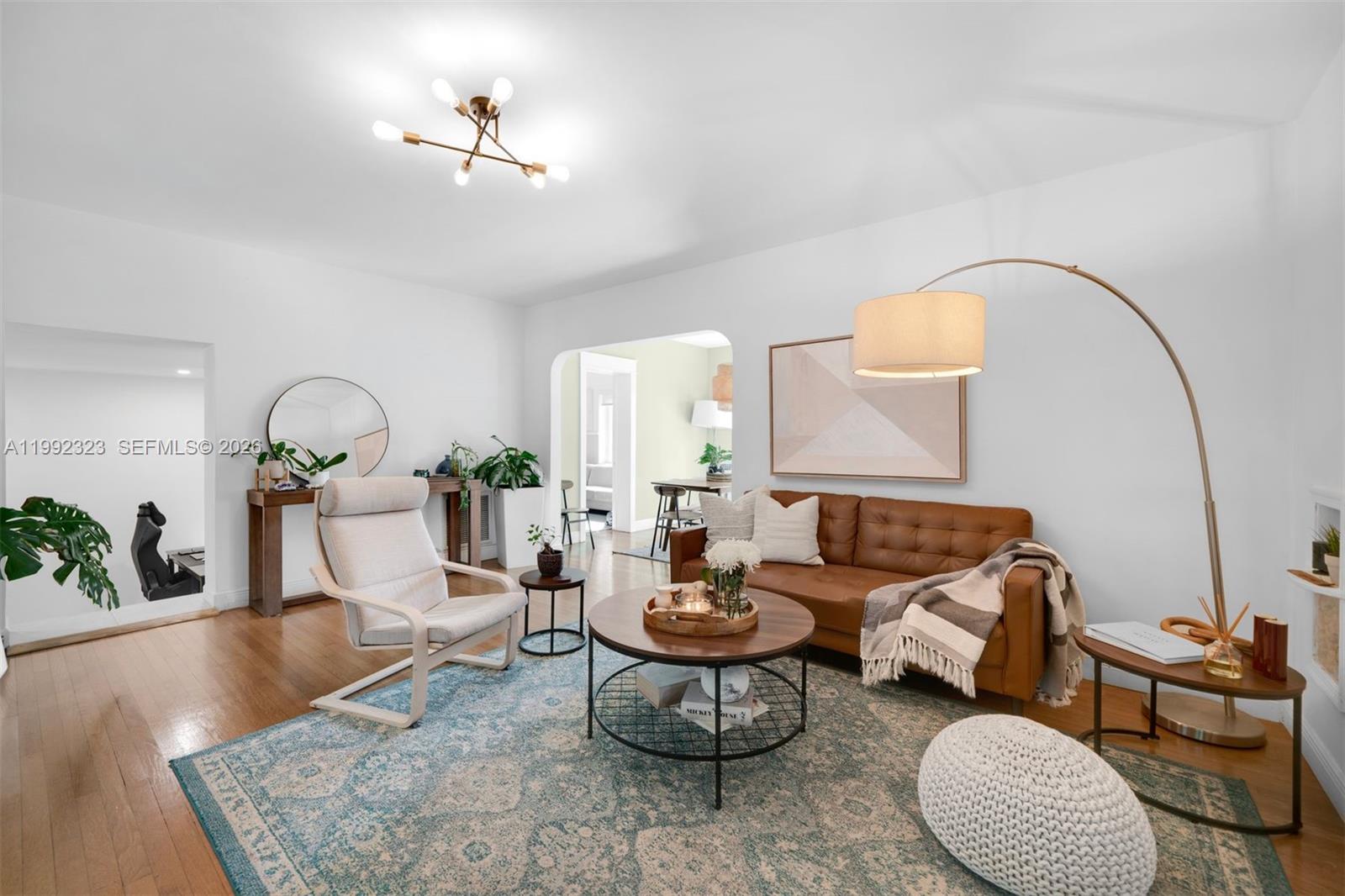 970 Northwest 10th Avenue Miami, FL 33136 - Photo 9 of 34 a living room with furniture a rug and a chandelier