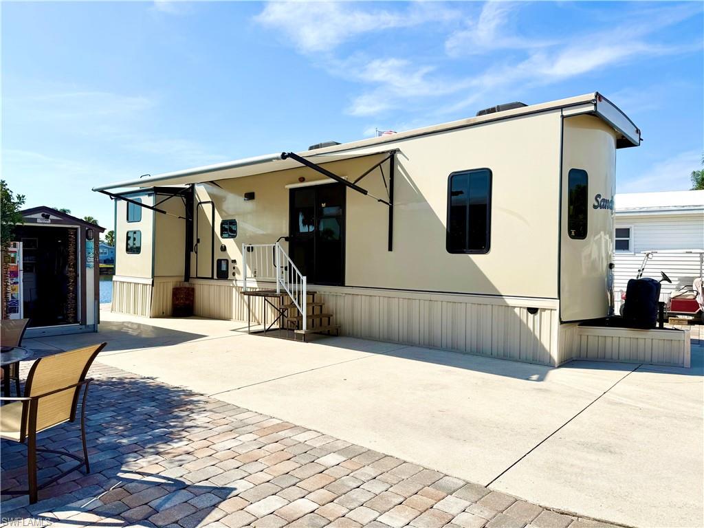 564 Cattleya Refuge, Unit 564 Naples, FL 34114 - Photo 2 of 50 a view of a house with backyard and a tree
