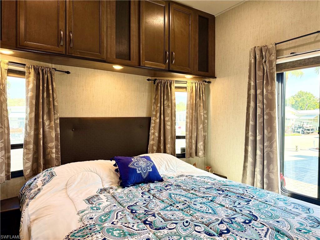 564 Cattleya Refuge, Unit 564 Naples, FL 34114 - Photo 26 of 50 a bedroom with a bed and a window