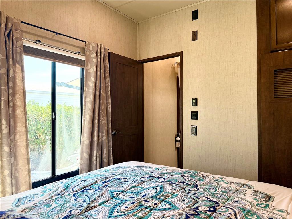 564 Cattleya Refuge, Unit 564 Naples, FL 34114 - Photo 27 of 50 a bedroom with a bed and a window