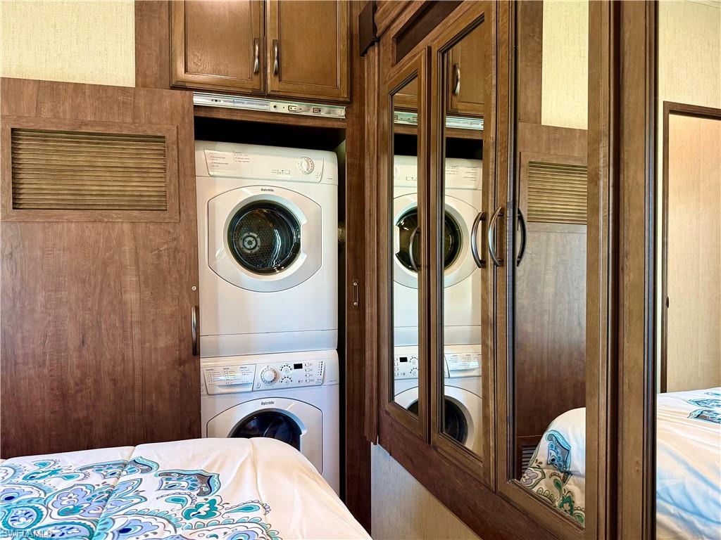 564 Cattleya Refuge, Unit 564 Naples, FL 34114 - Photo 28 of 50 a bedroom with a bed and glass window