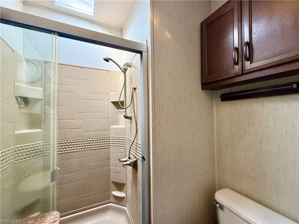 564 Cattleya Refuge, Unit 564 Naples, FL 34114 - Photo 31 of 50 a bathroom with a shower and toilet