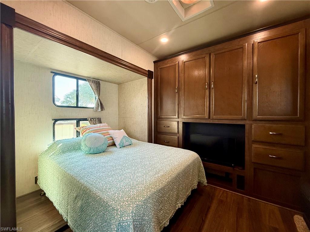 564 Cattleya Refuge, Unit 564 Naples, FL 34114 - Photo 33 of 50 a bedroom with a bed and a dresser
