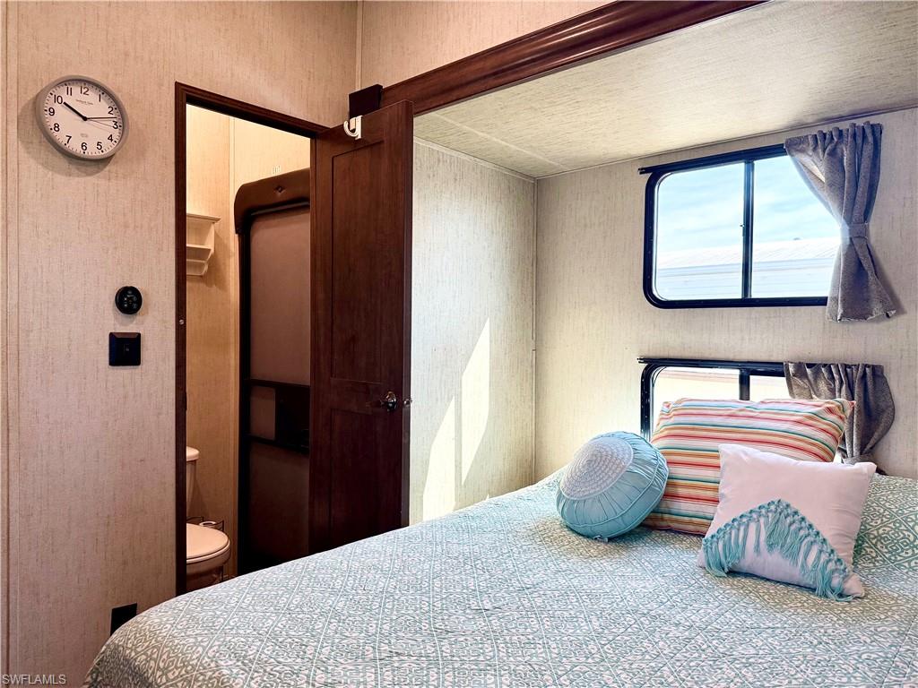 564 Cattleya Refuge, Unit 564 Naples, FL 34114 - Photo 38 of 50 a bedroom with bed and a window