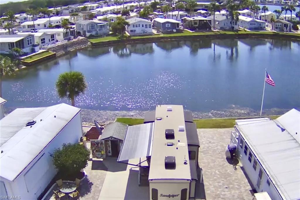 564 Cattleya Refuge, Unit 564 Naples, FL 34114 - Photo 4 of 50 an aerial view of a house with a lake view