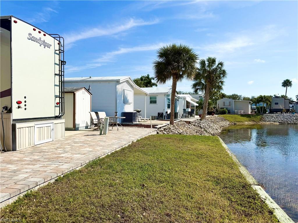 564 Cattleya Refuge, Unit 564 Naples, FL 34114 - Photo 7 of 50 a swimming pool with outdoor seating and yard