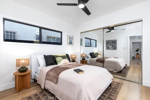 a bedroom with two beds and a painting on the wall