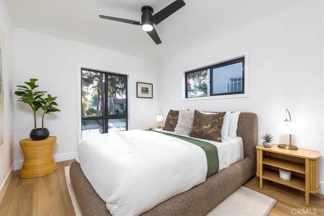 a bedroom with bed and a potted plant