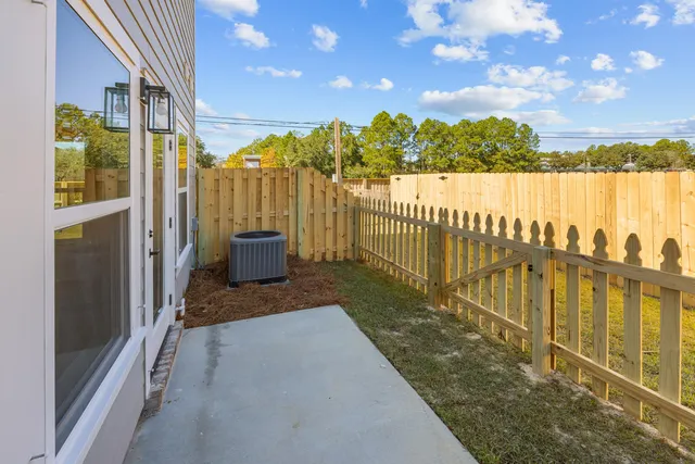a view of a pathway with a wrought fence