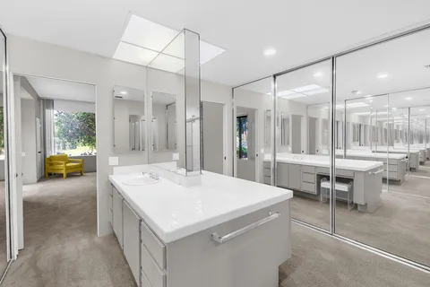 a spacious bathroom with a sink a mirror a shower and a bathtub