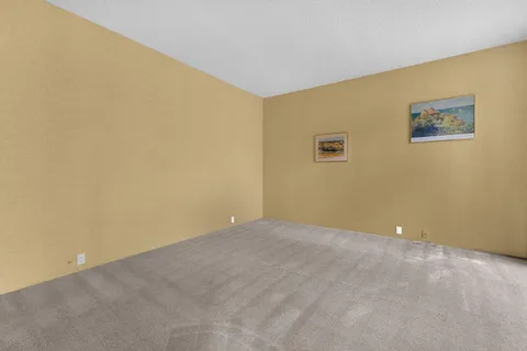 a view of empty room with sliding glass door and glass door