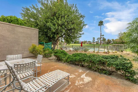 a patio with yard and outdoor seating