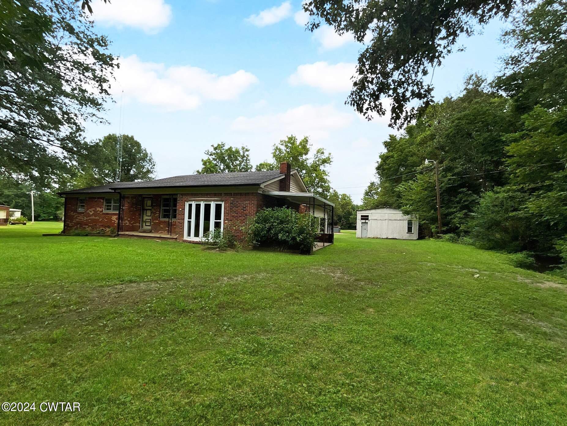 a front view of house with yard and green space