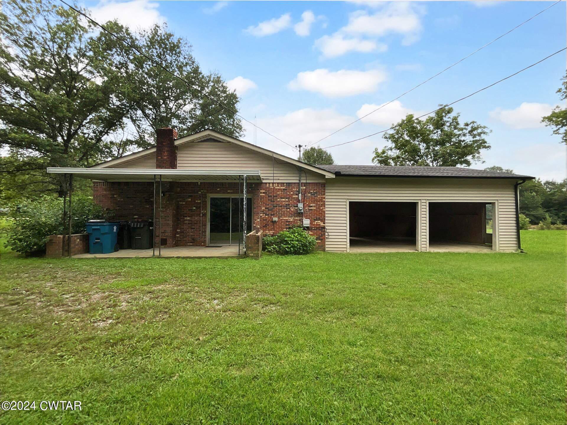 1255 Westport Road Huntingdon, TN 38344 - Photo 3 of 27 a front view of a house with a garden