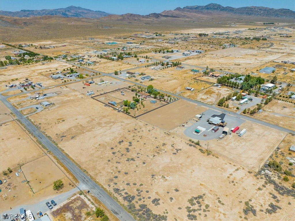 4580 Lawrence Road Pahrump, NV 89048 - Photo 34 of 40 A vast, open lot offers development potential amid distant mountain ranges.