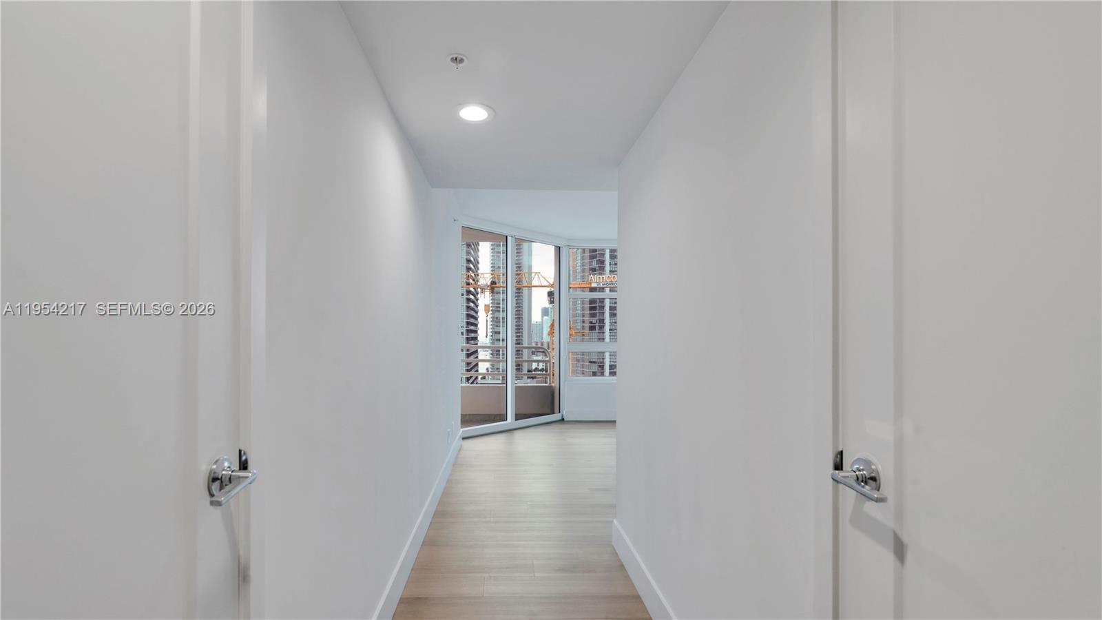 555 Northeast 34th Street, Unit 2201 Miami, FL 33137 - Photo 18 of 46 a view of a hallway with wooden floor and a bathroom