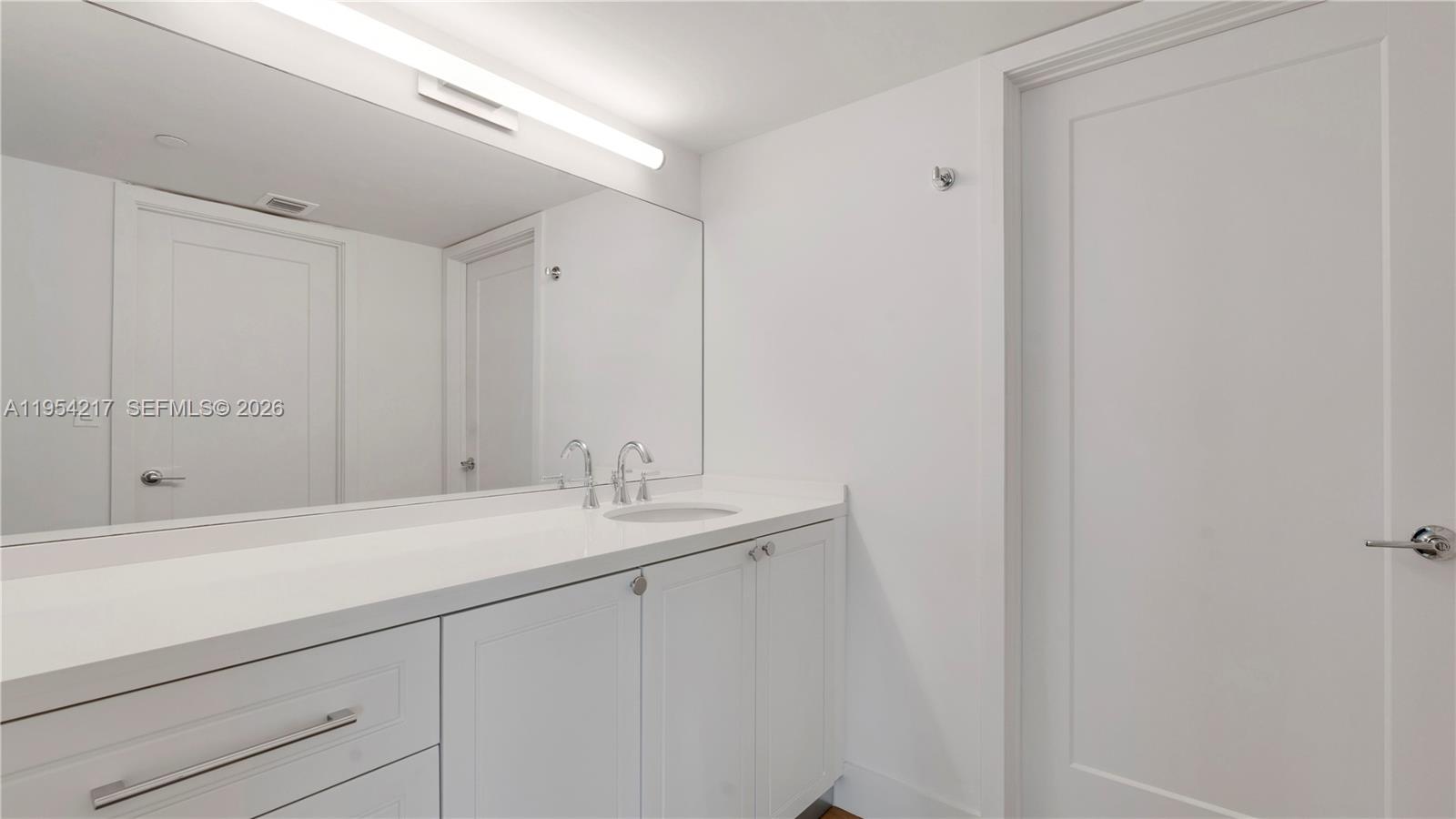 555 Northeast 34th Street, Unit 2201 Miami, FL 33137 - Photo 25 of 46 a bathroom with a sink and vanity