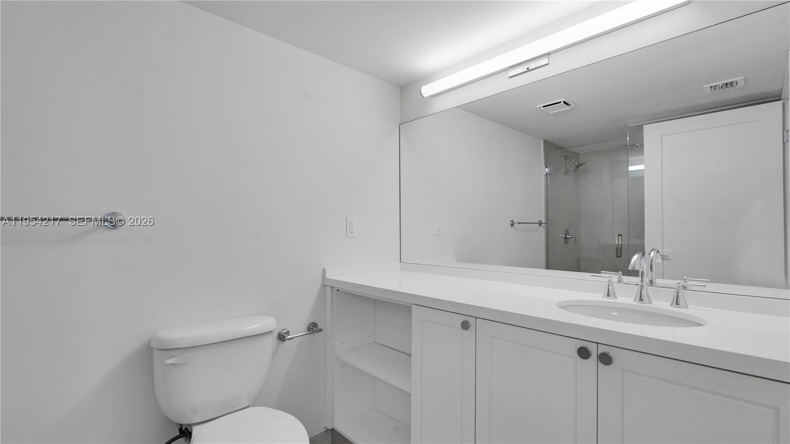 555 Northeast 34th Street, Unit 2201 Miami, FL 33137 - Photo 26 of 46 a bathroom with a toilet sink and mirror