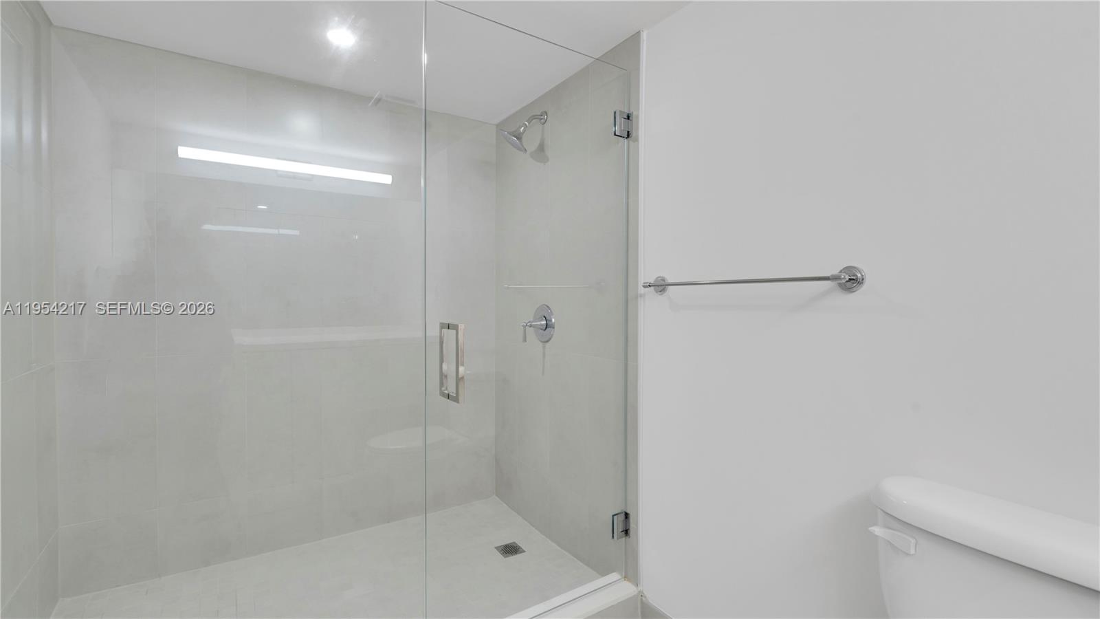 555 Northeast 34th Street, Unit 2201 Miami, FL 33137 - Photo 27 of 46 a bathroom with a shower and a toilet