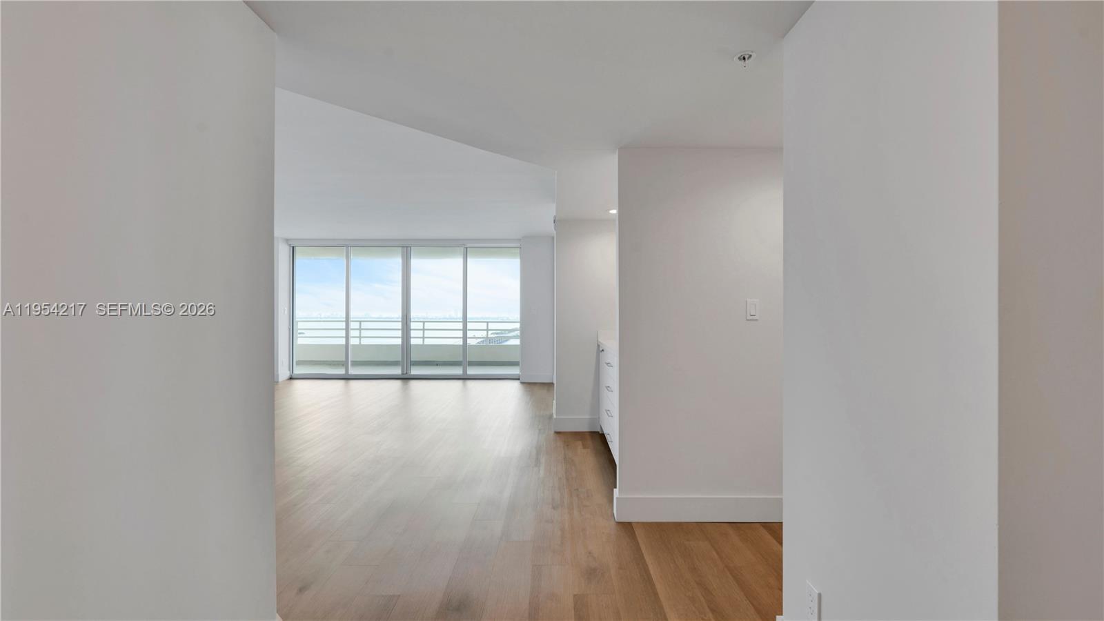 555 Northeast 34th Street, Unit 2201 Miami, FL 33137 - Photo 3 of 46 a view of empty room with wooden floor and fan