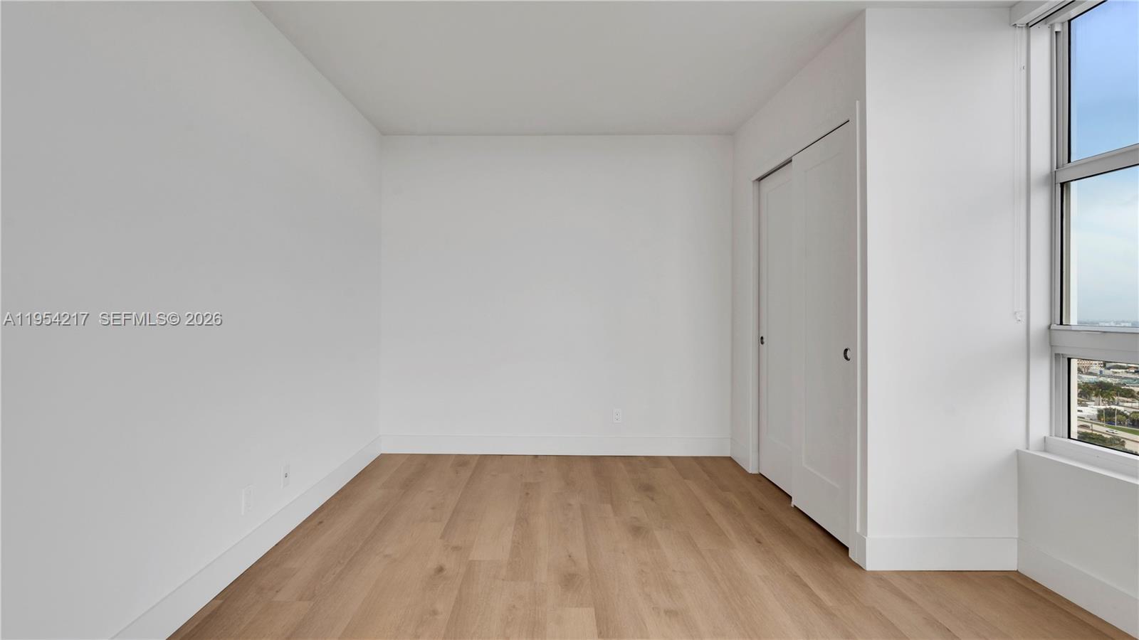 555 Northeast 34th Street, Unit 2201 Miami, FL 33137 - Photo 41 of 46 a view of empty room with wooden floor and fan