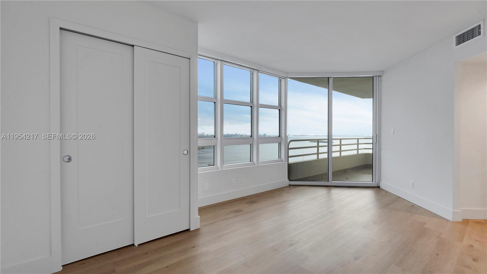 555 Northeast 34th Street, Unit 2201 Miami, FL 33137 - Photo 42 of 46 wooden floor in an empty room with a window
