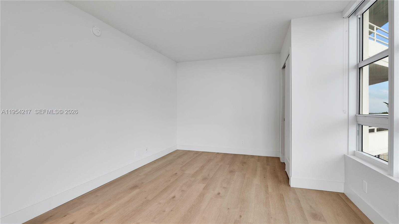 555 Northeast 34th Street, Unit 2201 Miami, FL 33137 - Photo 44 of 46 a view of a room that has wooden floor and cabinets