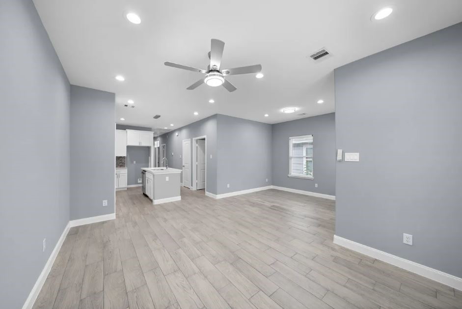 5222 Bataan Road Houston, TX 77033 - Photo 7 of 22 Open living space with modern flooring, elegant finishes, and seamless access to the heart of the home.
