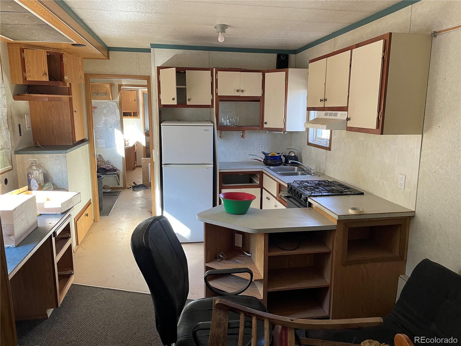5 Pewabic Mine Road Central City, CO 80427 - Photo 9 of 10 a kitchen with a table chairs stove and cabinets