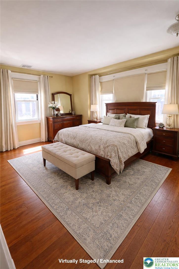 935 Easton Road Hellertown, PA 18055 - Photo 27 of 29 a spacious bedroom with a bed lamp on desk and a window