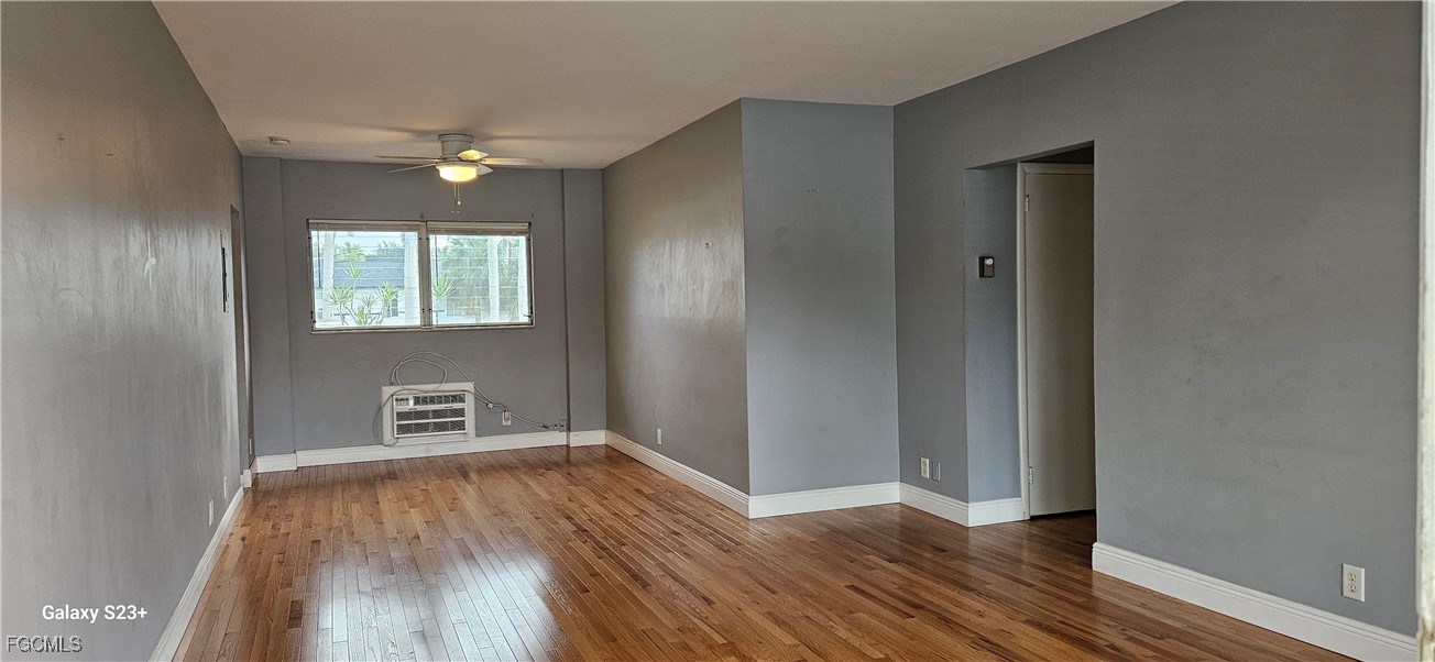 2544 First Street, Unit 202 Fort Myers, FL 33901 - Photo 5 of 20 wooden floor in an empty room with a window