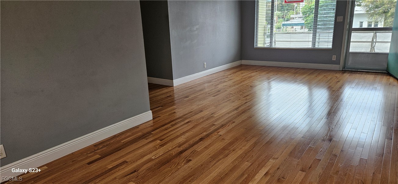 2544 First Street, Unit 202 Fort Myers, FL 33901 - Photo 6 of 20 a view of an empty room with wooden floor and a window