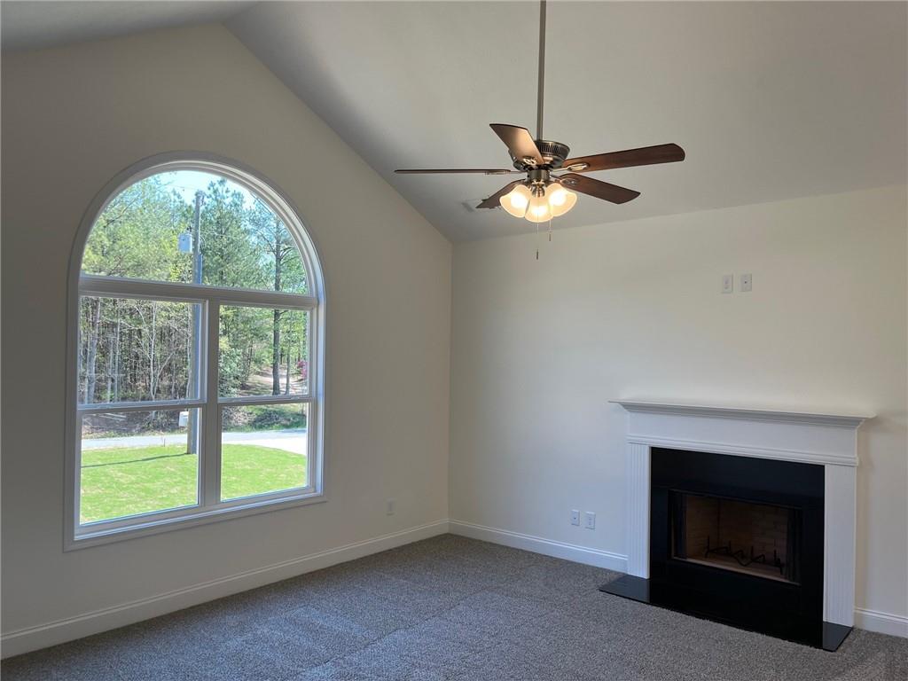 202 Gamel Road Dallas, GA 30157 - Photo 7 of 34 an empty room with chandelier fan and windows