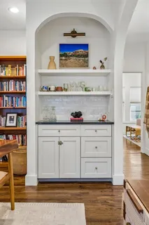 a view of white cabinets and wooden floor