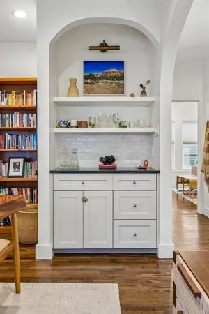 a view of white cabinets and wooden floor