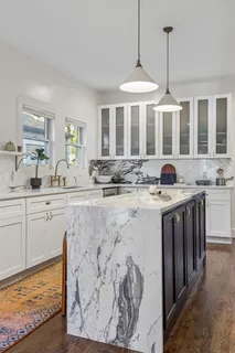 a kitchen with stainless steel appliances granite countertop a sink stove and cabinets