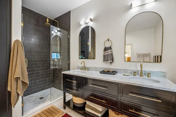 a bathroom with a double vanity sink and mirror