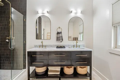 a bathroom with a double vanity sink and a mirror