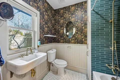 a bathroom with a toilet sink and mirror