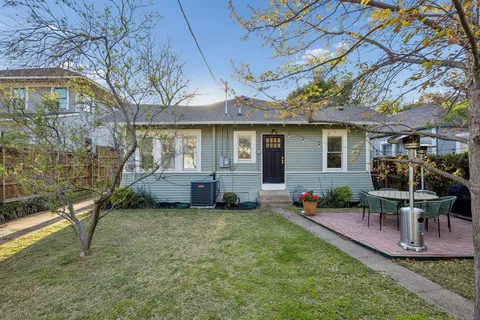 a view of a house with backyard porch and sitting area