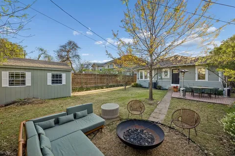 a view of a couches in patio of back yard