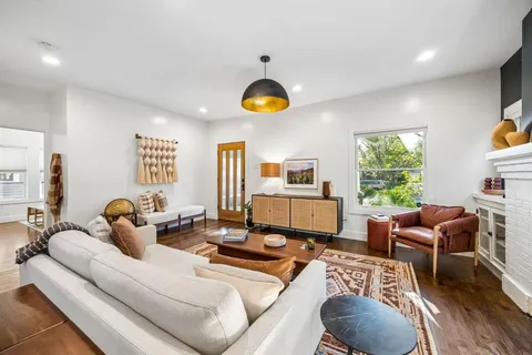 a living room with furniture fireplace and window
