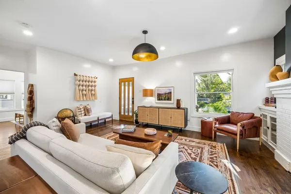 a living room with furniture fireplace and window