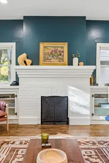 a living room with fireplace furniture and a fireplace